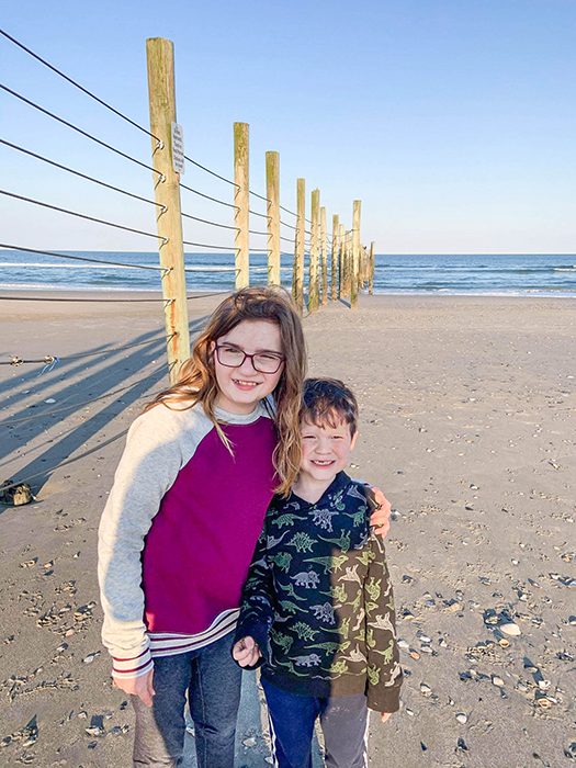 Jessica's son and daughter take a picture in front of their beach walk destination--the horse fence. 