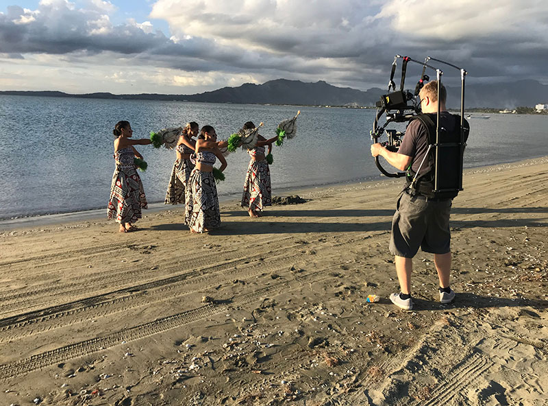 The film crew sets up a shot featuring Fijian dancers.