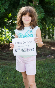 Daughter number two holds her First Day of 5th Grade sign.