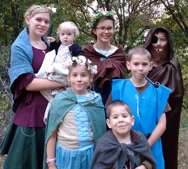 Grace, along with family and friends, dress in costumes while attending a history festival started by a homeschooling family.