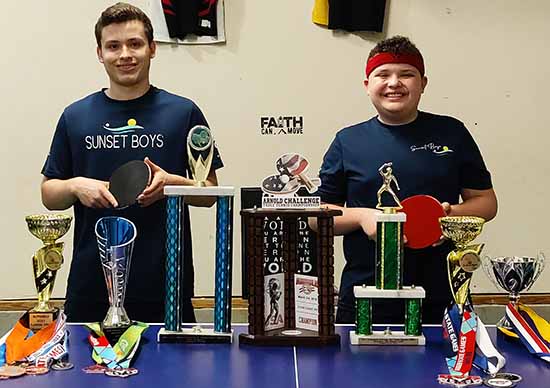 The Rios brothers display some of the awards they've earned as table tennis players.