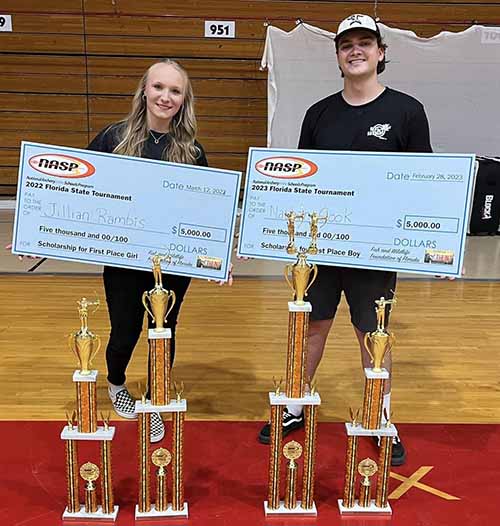 Jillian Rambis and Nathan Cook displaying trophies and the scholarships they earned.
